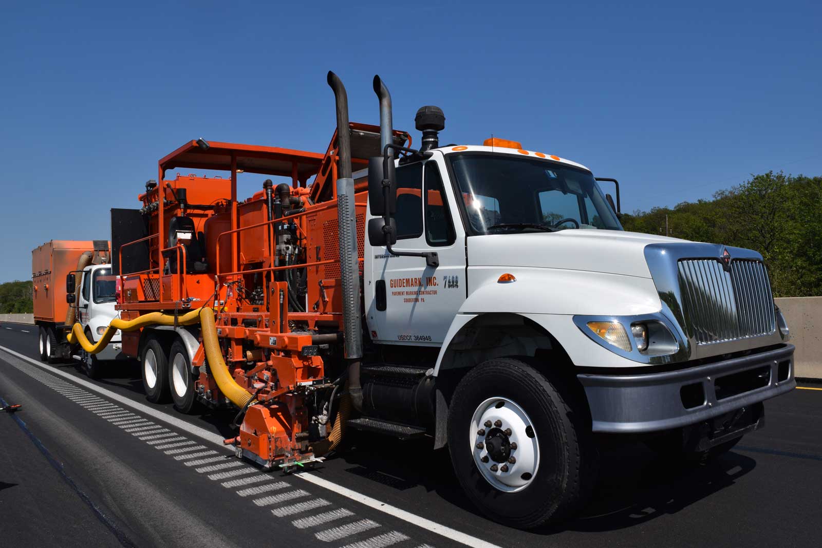 Grooving white edge line augmented with high capacity vacuum truck